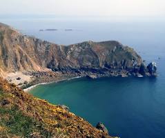 Rocky cliffs and a sheltered cove on the Cotentin coast near Cherbourg-en-Cotentin